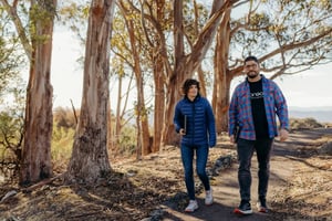 Geoneon founders Roxane and Alex walking through bushland in Tasmania.